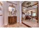 Elegant Primary bedroom with large bed, sitting area, and access to hallway at 7734 Still Lakes Dr, Odessa, FL 33556