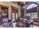 Luxurious home office with large windows and built-in shelving at 7734 Still Lakes Dr, Odessa, FL 33556