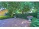 Brick courtyard with lush landscaping and ornate planters at 7734 Still Lakes Dr, Odessa, FL 33556