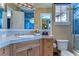Bathroom with light wood vanity, blue tile, and a corner sink at 7734 Still Lakes Dr, Odessa, FL 33556