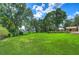 Expansive lawn with lush landscaping, offering serene lake views at 7734 Still Lakes Dr, Odessa, FL 33556