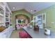 Bright office with built-in bookshelves, a comfortable seating area, and lake views at 7734 Still Lakes Dr, Odessa, FL 33556