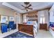 Spacious bedroom with a large bed, window seat, and built-in desk at 7734 Still Lakes Dr, Odessa, FL 33556