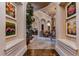 Stunning hallway with arched entryways and artwork at 7734 Still Lakes Dr, Odessa, FL 33556