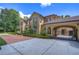 Elegant home with a gated entry and beautifully manicured landscaping at 7734 Still Lakes Dr, Odessa, FL 33556