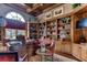 Spacious home office with built-in bookshelves and a large desk at 7734 Still Lakes Dr, Odessa, FL 33556