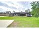 Large backyard with grassy area and screened pool at 108 Laurel Tree Way, Brandon, FL 33511