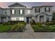 Charming townhome featuring a manicured lawn with lush landscaping, a walkway, and pleasant curb appeal at 14929 Promenade Pkwy, Odessa, FL 33556
