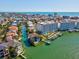 Aerial view captures the waterfront condo complex with docks, boat slips, a pool, and manicured landscaping on the serene water at 17745 Gulf Blvd # 604, Redington Shores, FL 33708