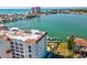 Scenic aerial view of condo community with waterfront access, boat docks, and serene views of the bay and city skyline at 17745 Gulf Blvd # 604, Redington Shores, FL 33708