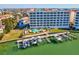 Aerial view of waterfront condo complex with a pool, boat docks, and beautifully landscaped grounds at 17745 Gulf Blvd # 604, Redington Shores, FL 33708