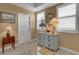 Bright bedroom features a decorative chest of drawers, an oval mirror, and natural lighting at 17745 Gulf Blvd # 604, Redington Shores, FL 33708