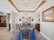 Traditional dining room with an elegant chandelier and a beautiful blue table cloth on the table at 17745 Gulf Blvd # 604, Redington Shores, FL 33708