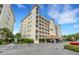 Beautiful condo building featuring multiple floors, balconies, and a covered parking area, nestled amidst lush landscaping at 17745 Gulf Blvd # 604, Redington Shores, FL 33708