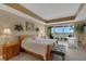 Comfortable main bedroom with a sliding glass door to a balcony and a beautiful view at 17745 Gulf Blvd # 604, Redington Shores, FL 33708