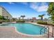 Inviting community swimming pool with palm trees and a marina backdrop on a clear, sunny day at 17745 Gulf Blvd # 604, Redington Shores, FL 33708