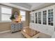 Bright sitting room with large hutch, glass top coffee table, and bright natural light at 17745 Gulf Blvd # 604, Redington Shores, FL 33708