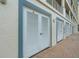 Exterior storage doors on a brick walkway, with trim that adds a charming architectural detail at 17745 Gulf Blvd # 604, Redington Shores, FL 33708