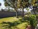 Landscaped backyard with lush green grass and large trees at 18833 Bent Pine Dr, Hudson, FL 34667