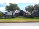 Community clubhouse with golf carts and welcoming entrance at 18833 Bent Pine Dr, Hudson, FL 34667