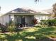 Cozy covered patio with seating and nicely landscaped yard at 18833 Bent Pine Dr, Hudson, FL 34667