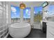 Spa-like bathroom with a large soaking tub and stunning lake views at 2905 Safe Harbor Dr, Tampa, FL 33618