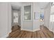 Light-filled hallway with wood-look floors and access to other rooms at 2905 Safe Harbor Dr, Tampa, FL 33618
