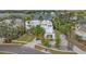 Aerial shot of a waterfront home surrounded by lush greenery with serene lake views and a paved driveway at 2905 Safe Harbor Dr, Tampa, FL 33618