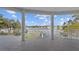 Covered balcony overlooking lake with white columns and railing at 2905 Safe Harbor Dr, Tampa, FL 33618