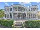 Expansive back exterior with multiple balconies overlooking a luxurious pool and manicured landscaping at 2905 Safe Harbor Dr, Tampa, FL 33618