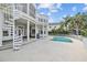 Stunning backyard featuring a swimming pool, spiral staircase, and a spacious patio area at 2905 Safe Harbor Dr, Tampa, FL 33618