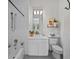 Well-lit bathroom with white tiling, a bathtub, shower, and vanity with modern lighting at 2905 Safe Harbor Dr, Tampa, FL 33618