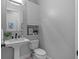 Powder room with pedestal sink, toilet and neutral paint at 2905 Safe Harbor Dr, Tampa, FL 33618