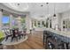 Open concept dining area with lake views, luxury lighting fixtures, and bar seating area with patterned counter at 2905 Safe Harbor Dr, Tampa, FL 33618