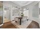 Bright dining room with modern light fixture, decorative glass blocks, and stylish wood flooring at 2905 Safe Harbor Dr, Tampa, FL 33618