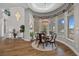Dining room featuring modern chandelier, large windows with beautiful backyard views, and luxury flooring at 2905 Safe Harbor Dr, Tampa, FL 33618