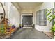 Inviting front entrance with a wooden bench, potted plants, and glass block window near double doors at 2905 Safe Harbor Dr, Tampa, FL 33618