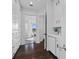 Bright hallway featuring built-in cabinets, a kitchenette, and access to a modern bathroom at 2905 Safe Harbor Dr, Tampa, FL 33618