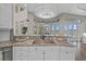 Modern kitchen with stainless steel sink, granite countertops, ample counter space, and modern pendant lights at 2905 Safe Harbor Dr, Tampa, FL 33618