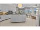 Open-concept kitchen with large island, ample cabinet space, granite countertops, and modern appliances at 2905 Safe Harbor Dr, Tampa, FL 33618