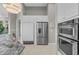 Modern kitchen featuring stainless steel refrigerator, microwave, granite countertops, and bright lighting at 2905 Safe Harbor Dr, Tampa, FL 33618