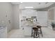 Open laundry room with granite countertops, storage, utility sink and modern finishes at 2905 Safe Harbor Dr, Tampa, FL 33618