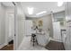 Bright laundry room featuring an island, plenty of storage, and utility sink with modern fixtures at 2905 Safe Harbor Dr, Tampa, FL 33618