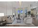 Open living room with lake views, high ceilings, stylish furniture, and a modern chandelier at 2905 Safe Harbor Dr, Tampa, FL 33618