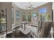 A home office features a ceiling fan, multiple windows, and a comfortable chair at 2905 Safe Harbor Dr, Tampa, FL 33618