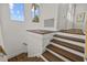Modern staircase with dark wood steps and white risers at 2905 Safe Harbor Dr, Tampa, FL 33618