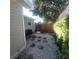Small backyard with gravel ground cover, stone pathway, and wooden fence at 3751 67Th N Ave, Pinellas Park, FL 33781