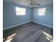Bright bedroom with ceiling fan and gray laminate flooring at 3751 67Th N Ave, Pinellas Park, FL 33781