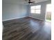 Living room with gray laminate flooring and sliding door to patio at 3751 67Th N Ave, Pinellas Park, FL 33781