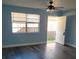 Spacious living area with gray laminate flooring and access to patio at 3751 67Th N Ave, Pinellas Park, FL 33781